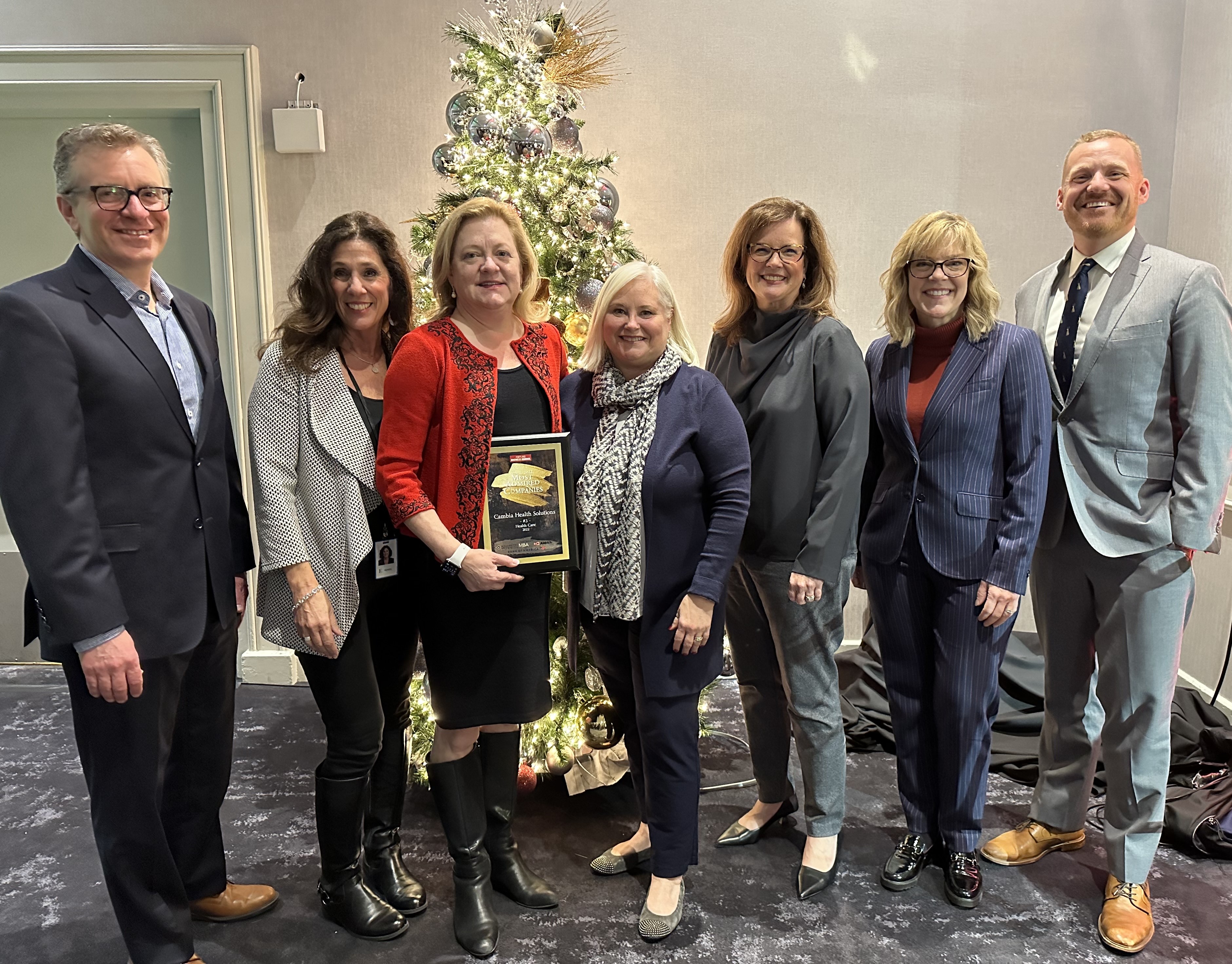 Group of professionals standing with an award plaque