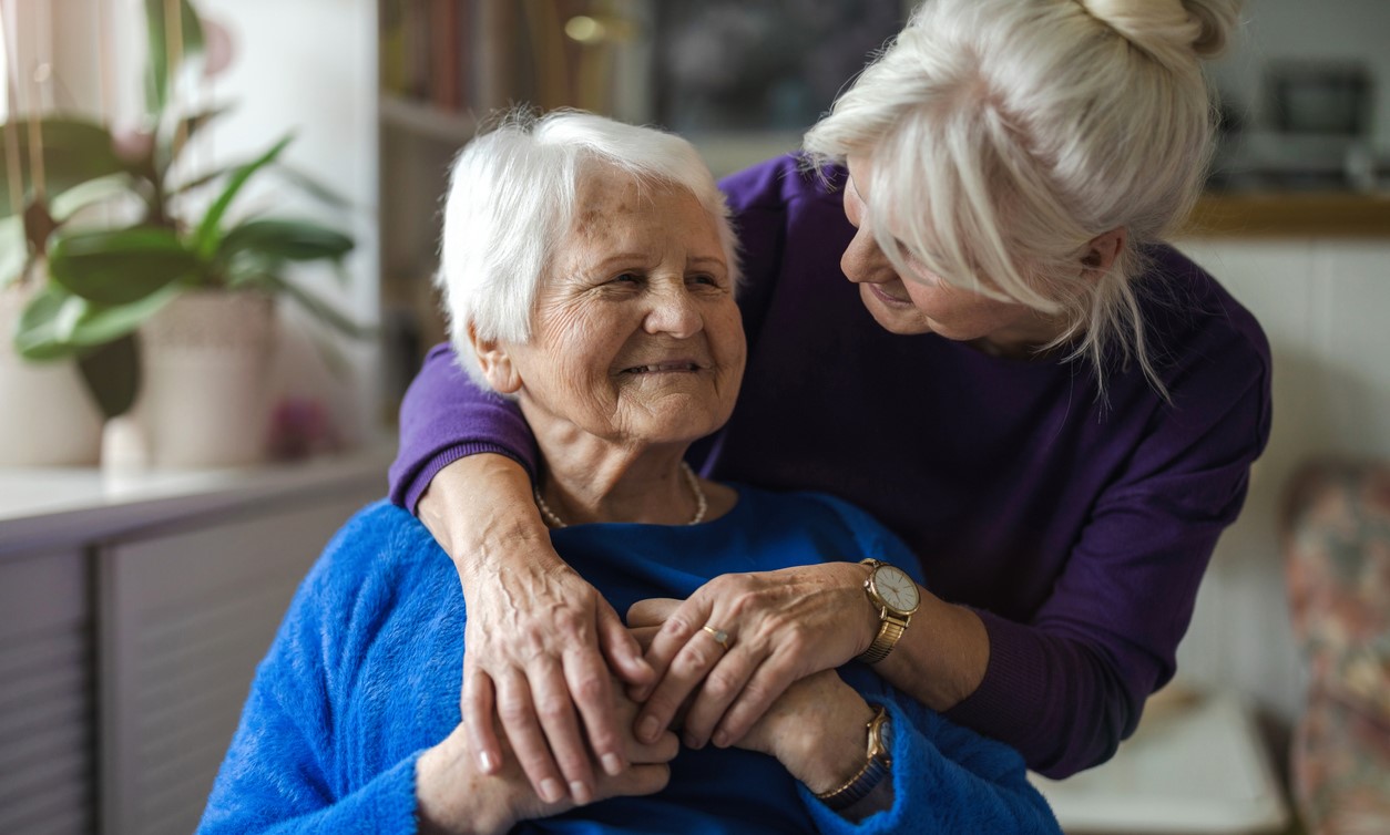 Two older women embracing