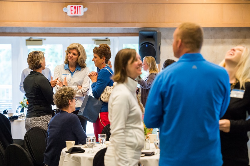 An image of folks talking with one another at an event