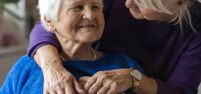 Two older women embracing