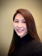 Professional headshot of women with long brown hair