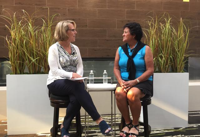 gail baker and nancy lopez speaking on stage