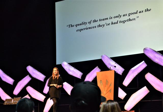 Meg Dryer gives a speech on a stage about transforming health care