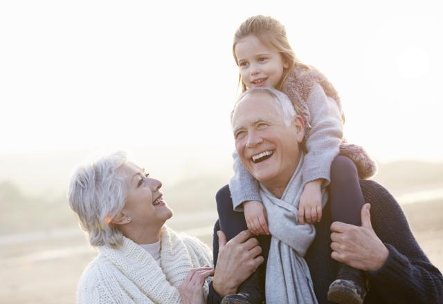 grandparents with grandchild on grandpa's back