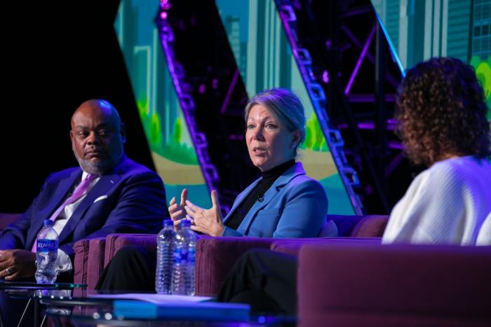 Dr. Marion Couch sits with Greg Deavens and Carrie Nixon for a panel on reimbursement policy