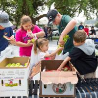 Children eating fresh fruits and vegtables Cambia Giving Tuesday