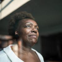 Older woman looking out of a window