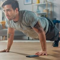 Man in his living room doing a push up