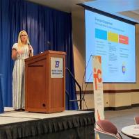 Woman at a podium giving presentation