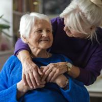 Two older women embracing