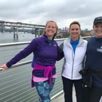 three women standing in front of water