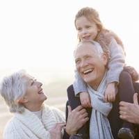 grandparents with grandchild on grandpa's back