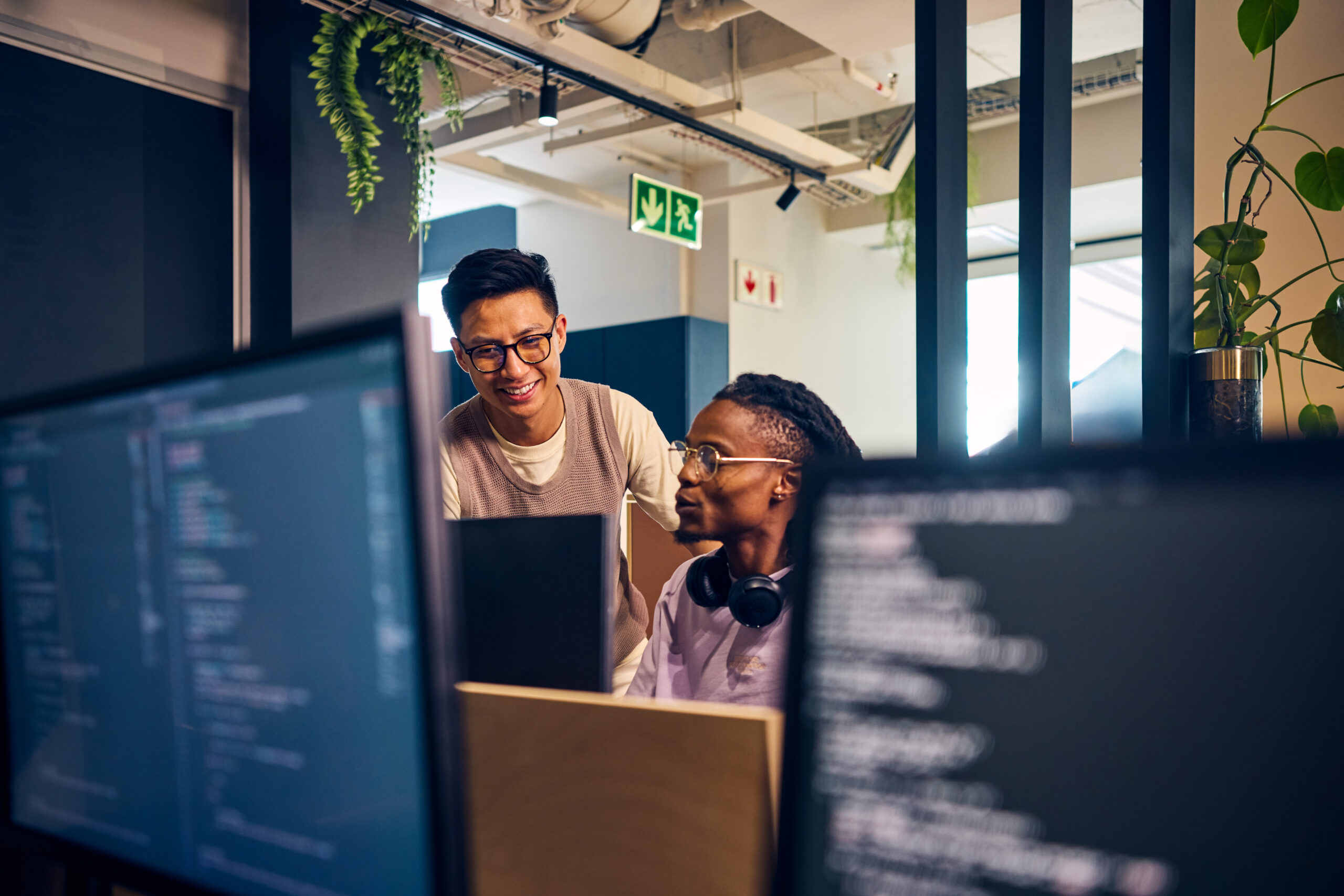 Two men looking at a computer screen